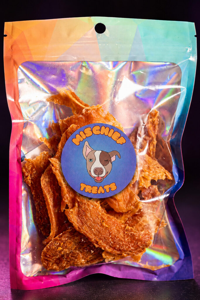 Mischief Treats Fish dog-treat pouch against a dark studio background