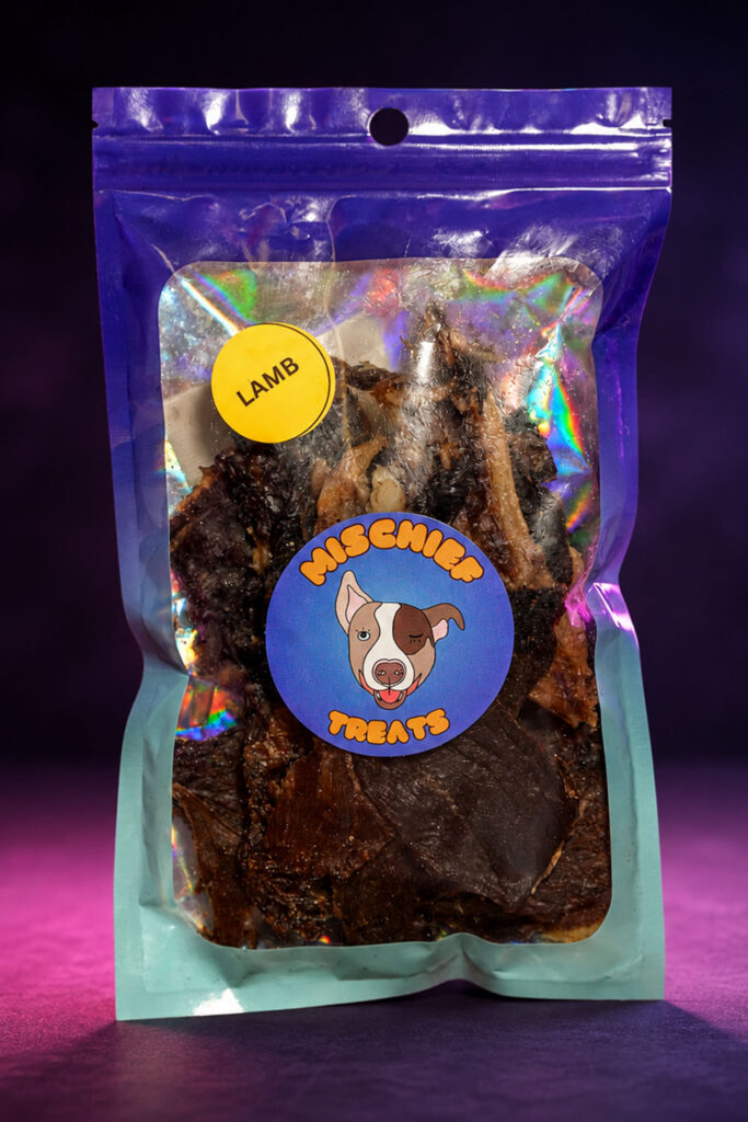 Mischief Treats Lamb dog-treat pouch against a dark studio background